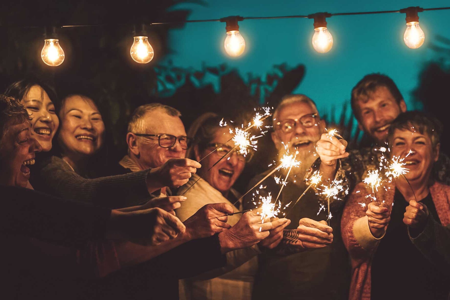 adults enjoying sparklers