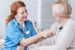 nurse checking a senior's blood pressure