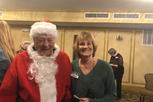 man in Santa costume with a woman