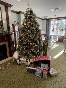 Christmas tree with toys spilling out of a gift box